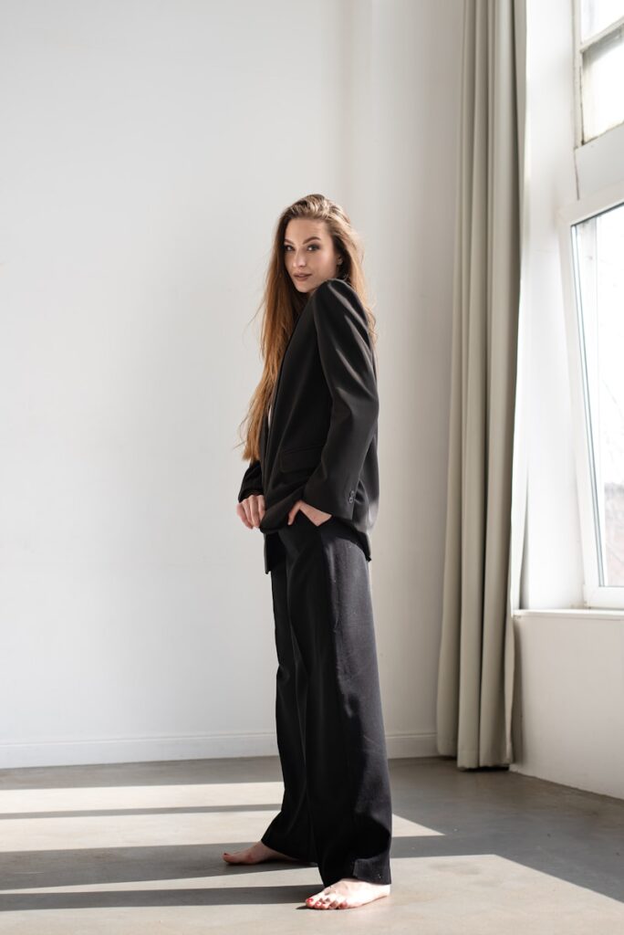 a woman standing in front of a window