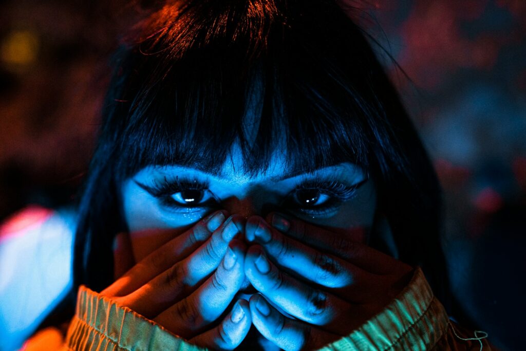 a woman covering her face with her hands