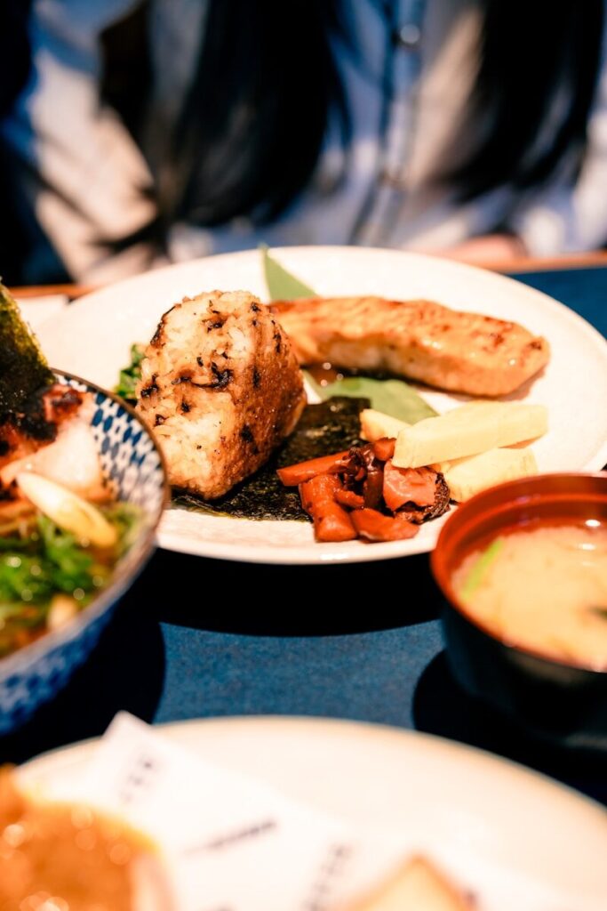 A table topped with plates of food and a bowl of soup