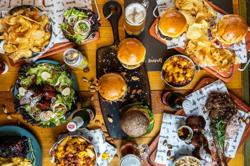 a wooden table topped with lots of food